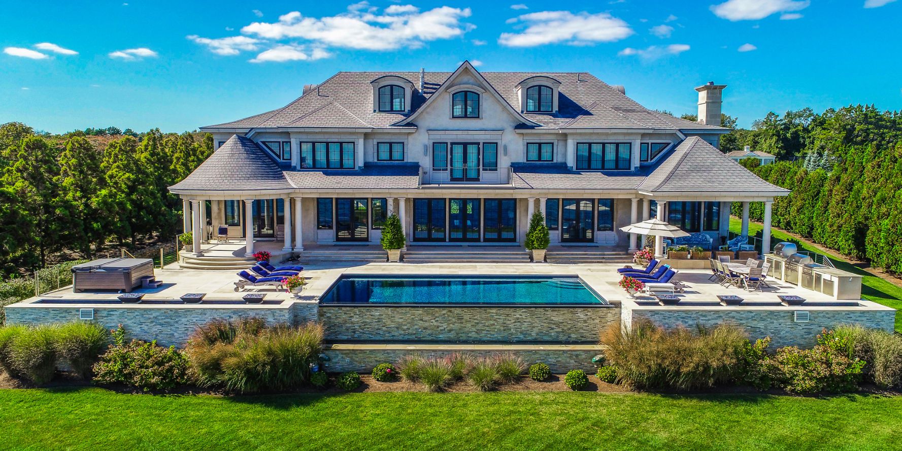 Exterior aerial shot of a mansion and back yard